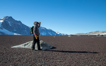 Woman standing on a barren landscape